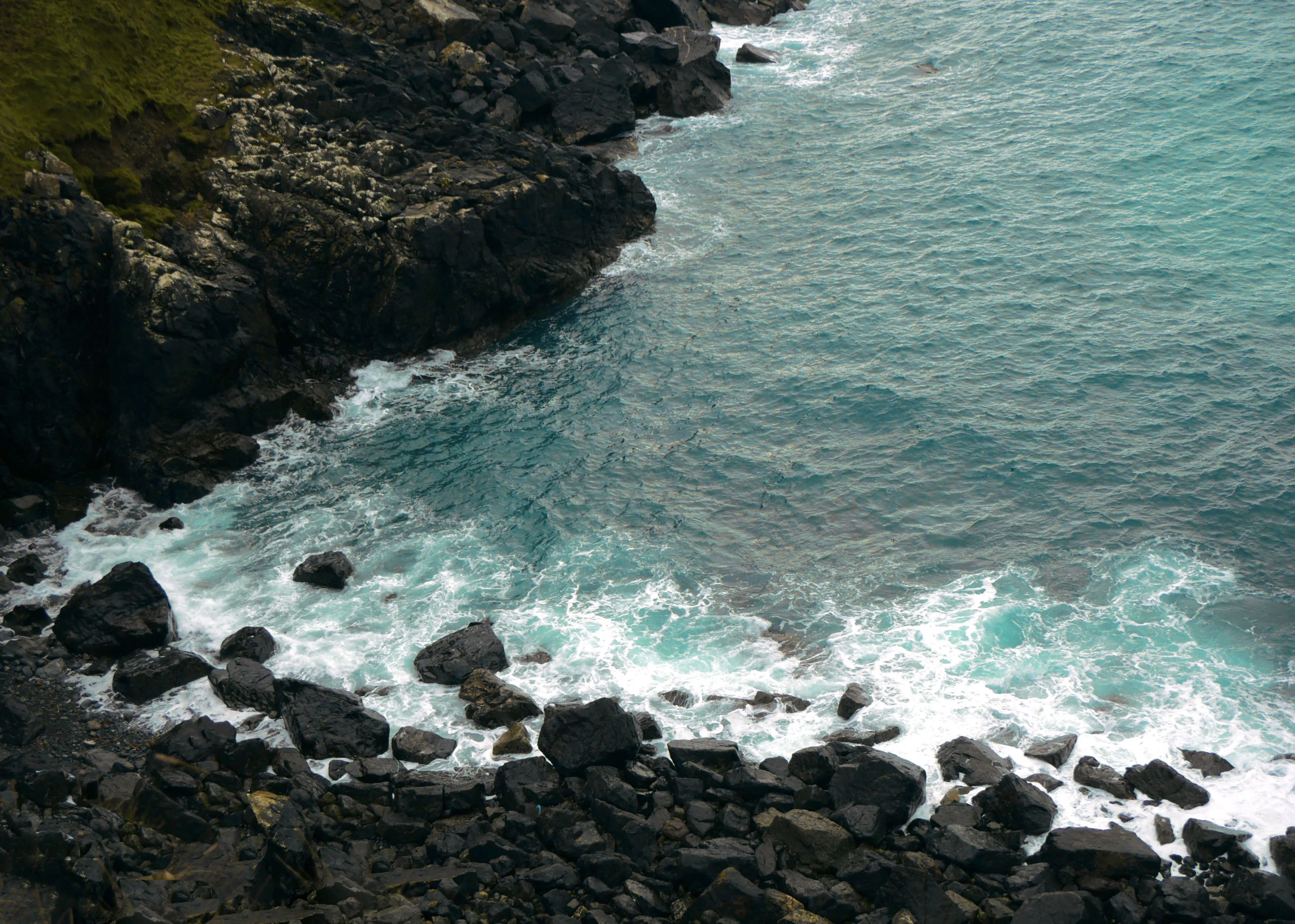 Rocky Cornish coastline meeting turquoise sea